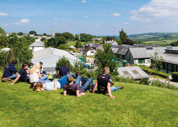 Students sitting on the grass at a sunny Stoke Climsland